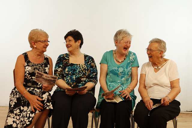 four women laugh in the midst of engaged conversation