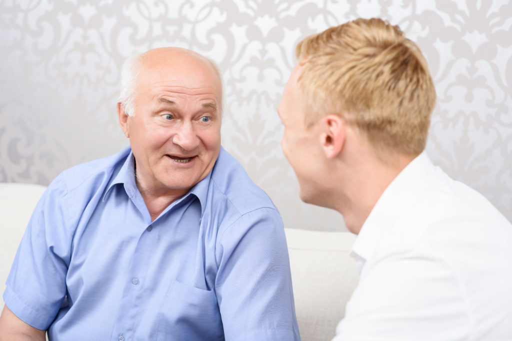 Sweet conversation. Portrait of grandfather and grandson sitting and expressive talking to each other.