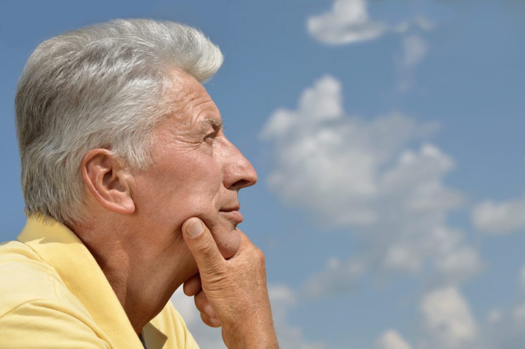 A man with his hand under his chin, as if in contemplative thought