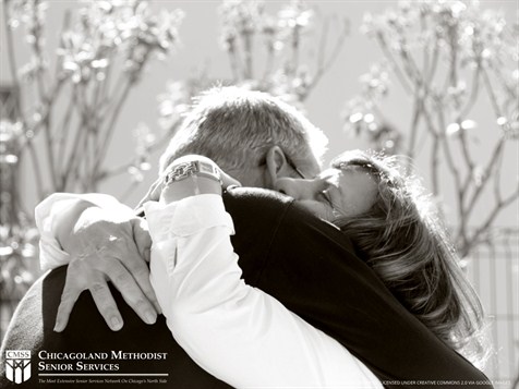 A black and white photo of a couple embraced in a hug