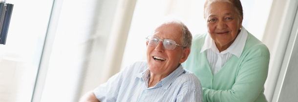 Two senior adults smile while posing for a picture