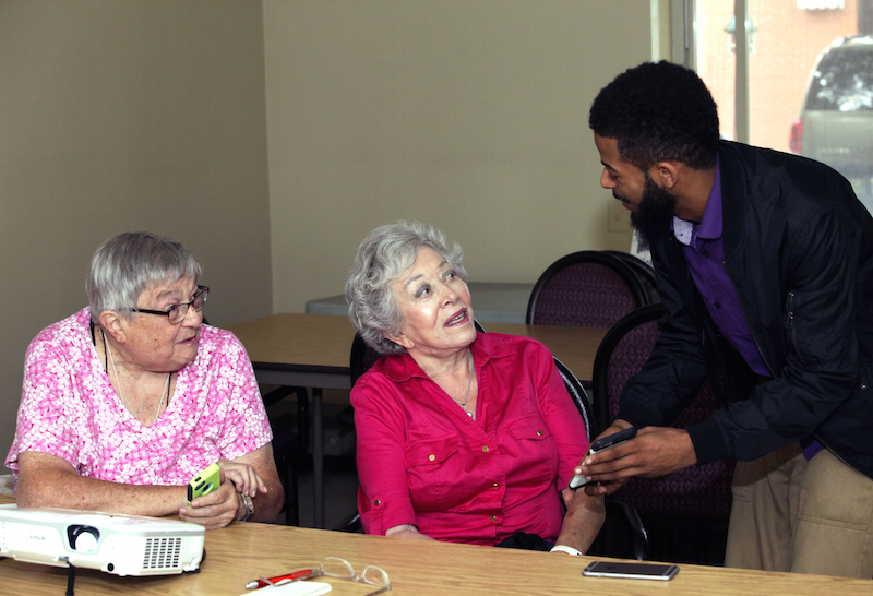 two women getting support with computer classes for seniors at CMSS