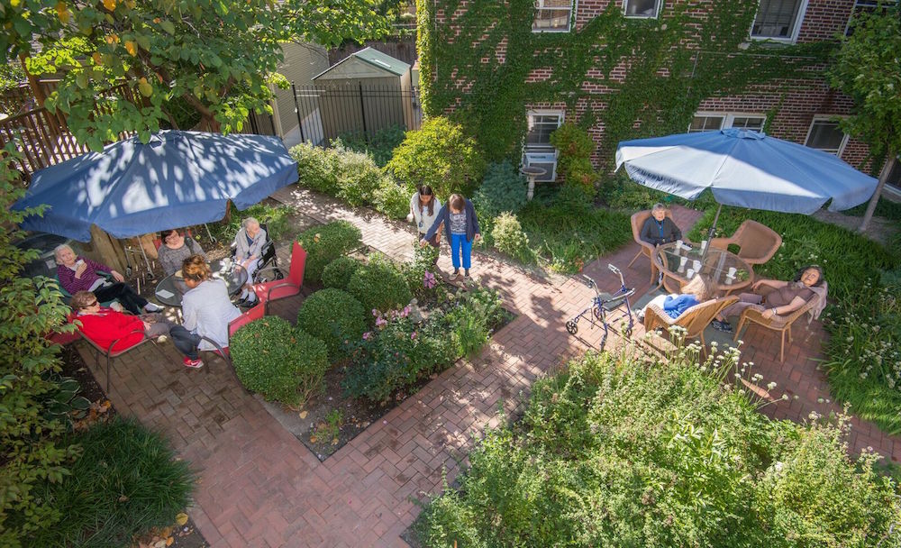 Groups of people enjoy the gardens at the Hartwell Place