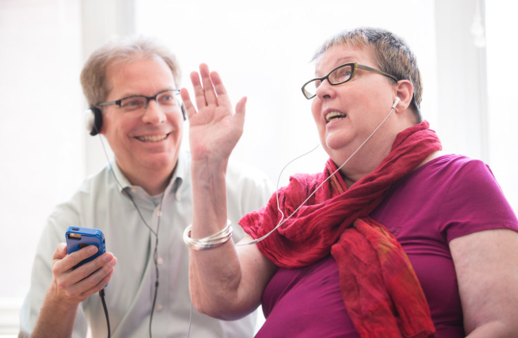 A woman listens to music on her headphones as part of a music therapy memory program