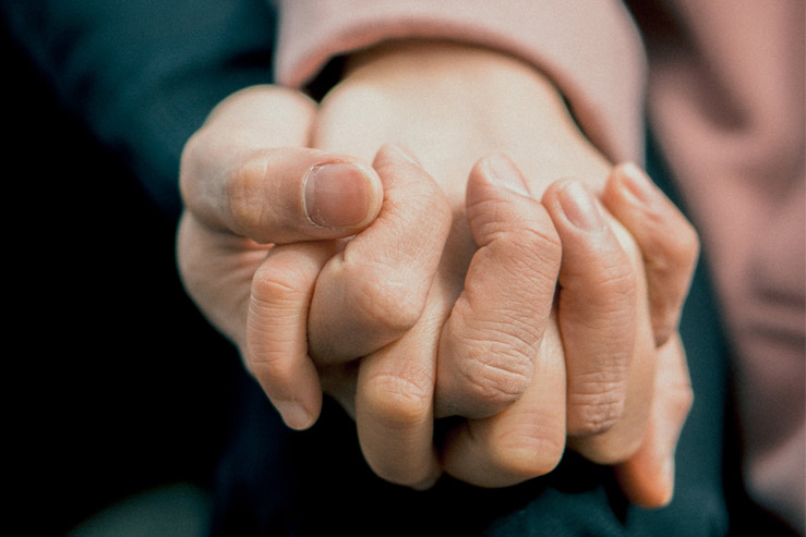 A pair of hands interlocked in a sign of solidarity