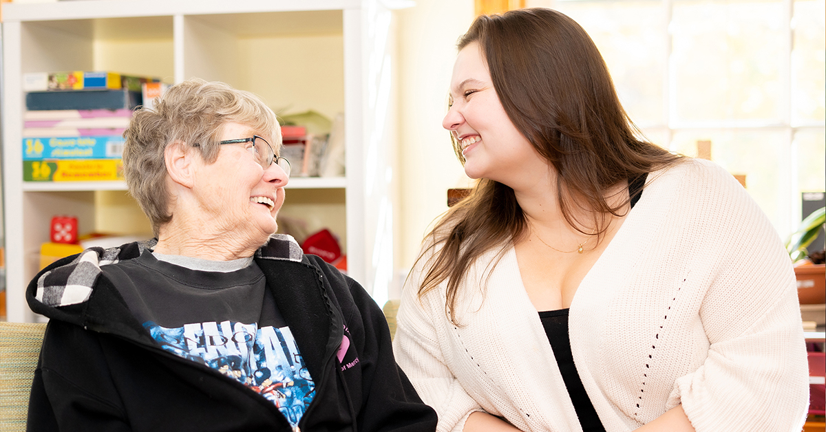 Image of two women smiling at each other.