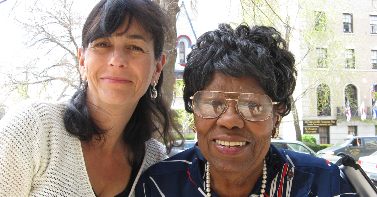 Image of caregiver and older adult smiling.