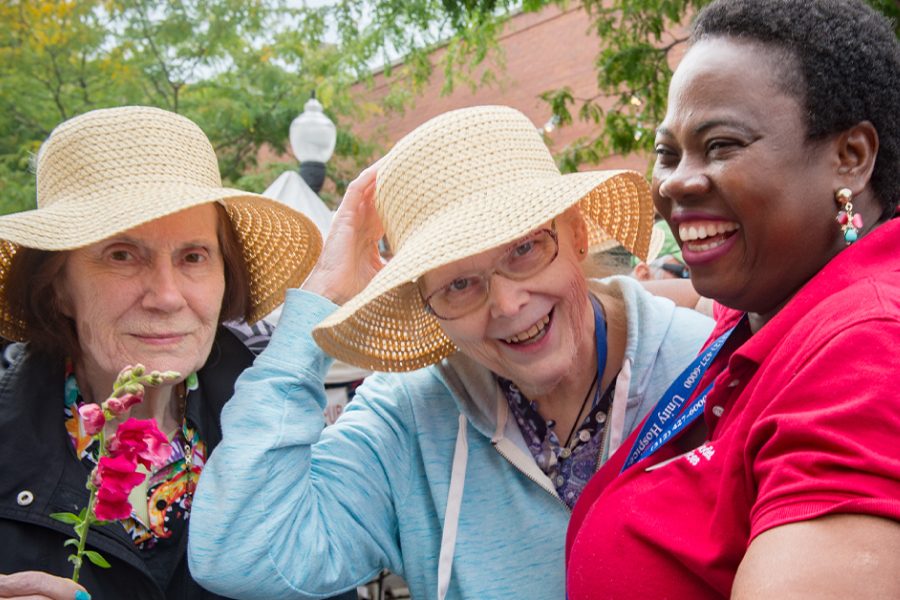 Two white elder women with a Black senior care provider.