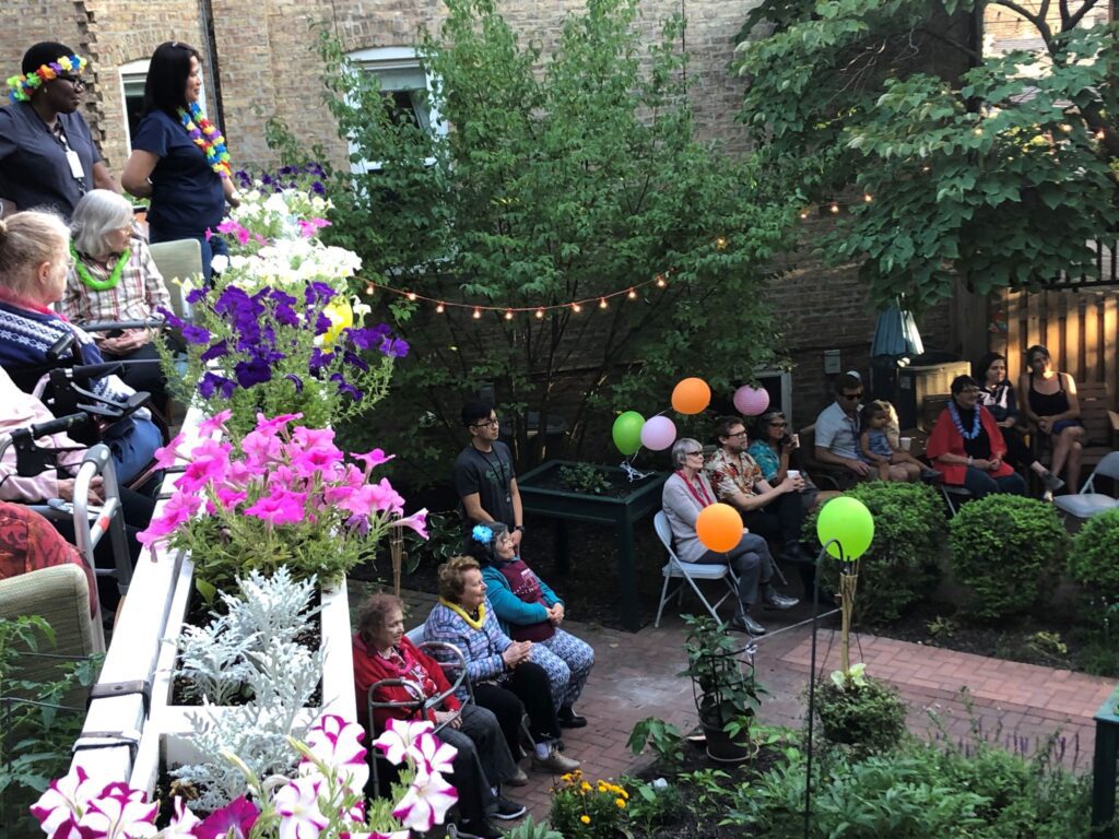 A view of a garden party at Hartwell Place with balloons and flowers.