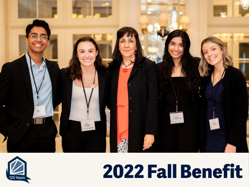 Four students and their mentor pose for the camera at a business formal event.