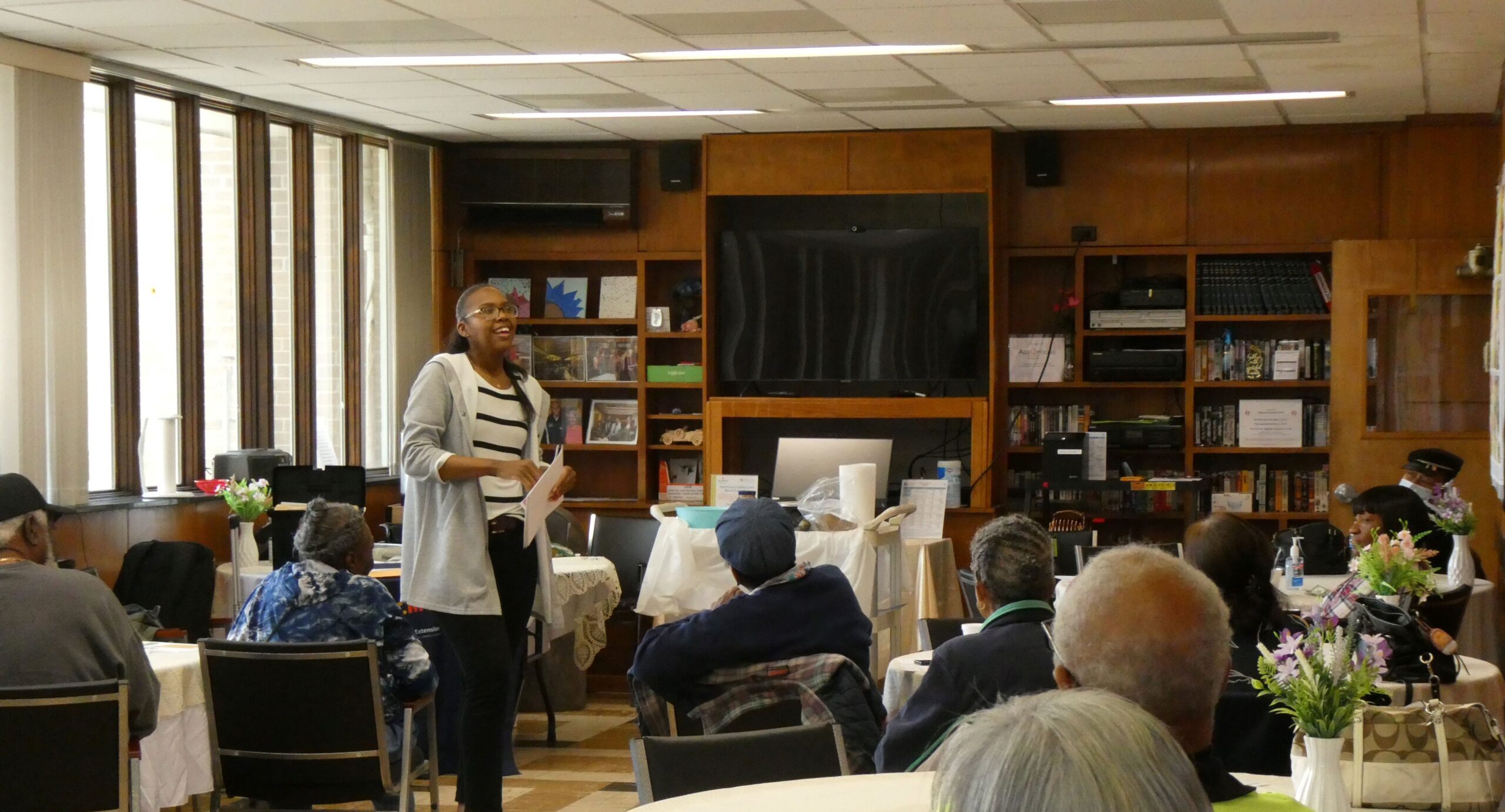 A woman presents to a room of older adults.